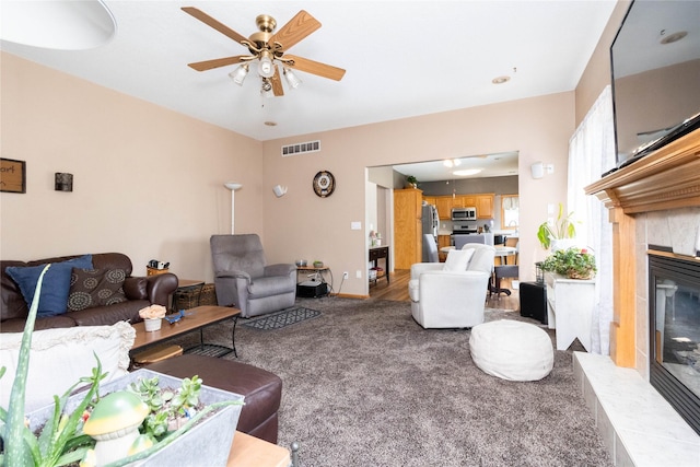 7129 Ridgedale Ct, Johnston, IA 50131 - living room with carpet floors, a fireplace, and a ceiling fan