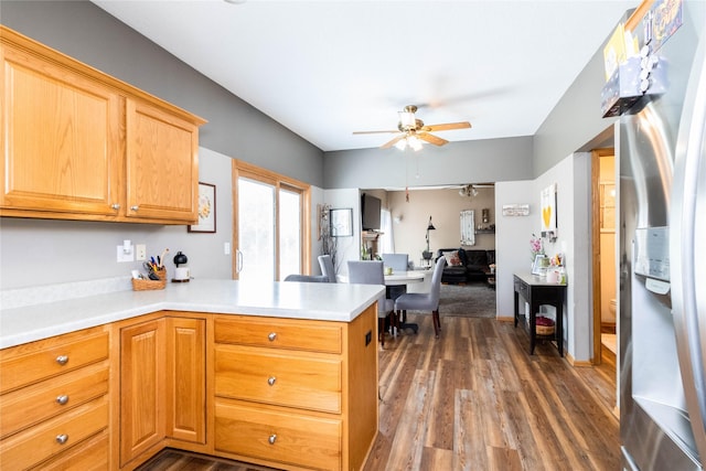 7129 Ridgedale Ct, Johnston, IA 50131 - kitchen with stainless steel refrigerator with ice dispenser, a ceiling fan, a peninsula, and dark wood-style flooring