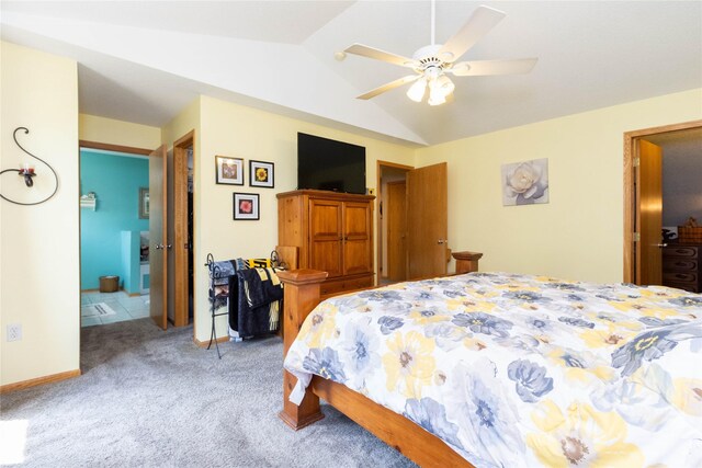 7129 Ridgedale Ct, Johnston, IA 50131 - carpeted bedroom with vaulted ceiling, connected bathroom, and a ceiling fan