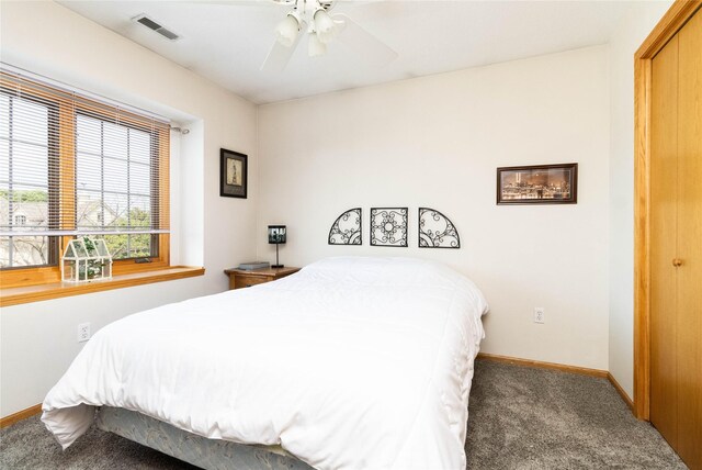 7129 Ridgedale Ct, Johnston, IA 50131 - carpeted bedroom with baseboards and a ceiling fan