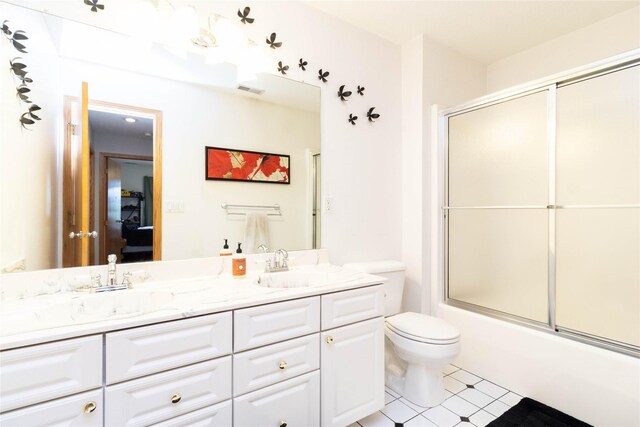 7129 Ridgedale Ct, Johnston, IA 50131 - bathroom featuring double vanity, enclosed tub / shower combo, and tile patterned flooring