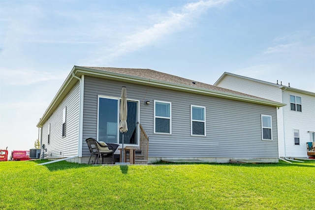 6828 NW 106th St, Johnston, IA 50131 - rear view of house with central air condition unit and a yard