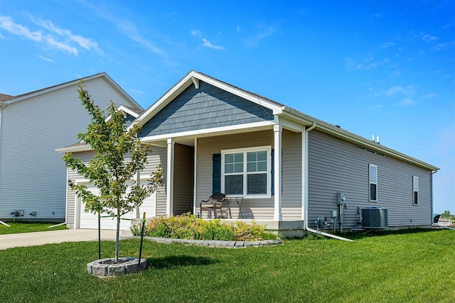 6828 NW 106th St, Johnston, IA 50131 - view of front facade with a front yard, a garage, driveway, a porch, and central air condition unit