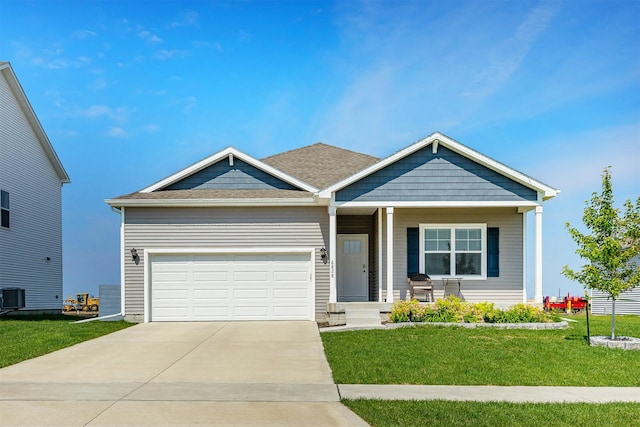 6828 NW 106th St, Johnston, IA 50131 - view of front facade featuring a front lawn, concrete driveway, covered porch, a garage, and central AC