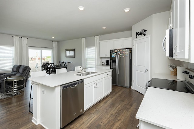 6828 NW 106th St, Johnston, IA 50131 - kitchen featuring stainless steel appliances, a sink, light countertops, dark wood-style flooring, and white cabinetry