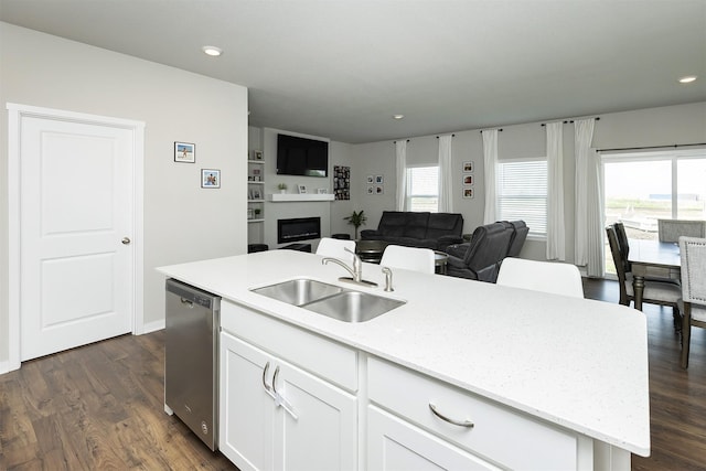 6828 NW 106th St, Johnston, IA 50131 - kitchen featuring dishwasher, a sink, a kitchen island with sink, white cabinets, and open floor plan