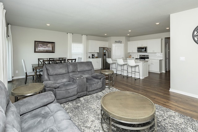 6828 NW 106th St, Johnston, IA 50131 - living area featuring dark wood-style floors, recessed lighting, and baseboards