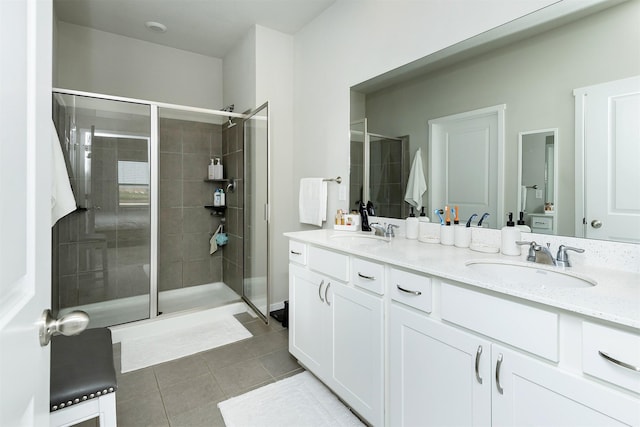 6828 NW 106th St, Johnston, IA 50131 - bathroom featuring double vanity, a shower stall, and tile patterned floors