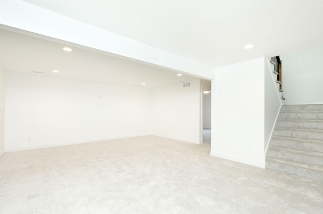 2412 NE 6th St, Grimes, IA 50111 - finished basement with stairs, light colored carpet, recessed lighting, and baseboards