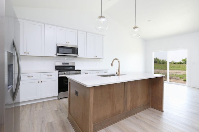 2412 NE 6th St, Grimes, IA 50111 - kitchen with stainless steel appliances, a sink, decorative backsplash, light wood-style flooring, and high vaulted ceiling