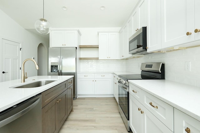 2412 NE 6th St, Grimes, IA 50111 - kitchen featuring appliances with stainless steel finishes, a sink, open shelves, and light countertops