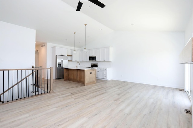 2412 NE 6th St, Grimes, IA 50111 - kitchen featuring appliances with stainless steel finishes, open floor plan, a ceiling fan, light countertops, and a sink