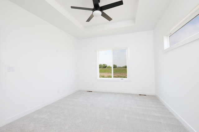 2412 NE 6th St, Grimes, IA 50111 - carpeted empty room featuring a raised ceiling, a ceiling fan, and baseboards