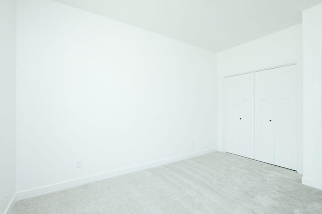 2412 NE 6th St, Grimes, IA 50111 - unfurnished bedroom with carpet, a closet, and baseboards