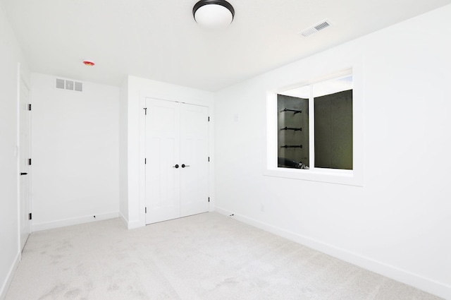 2412 NE 6th St, Grimes, IA 50111 - unfurnished bedroom featuring carpet, baseboards, and a closet