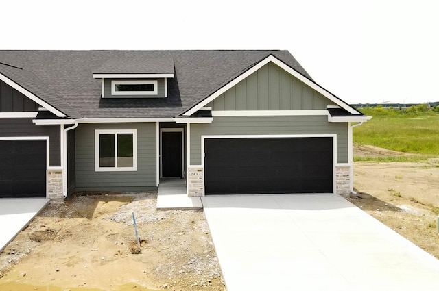 2412 NE 6th St, Grimes, IA 50111 - craftsman inspired home with stone siding, board and batten siding, concrete driveway, and a shingled roof