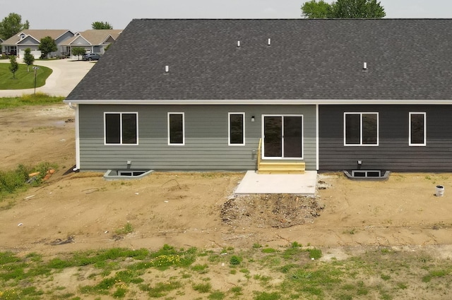 2412 NE 6th St, Grimes, IA 50111 - rear view of house featuring entry steps, a shingled roof, and a patio area