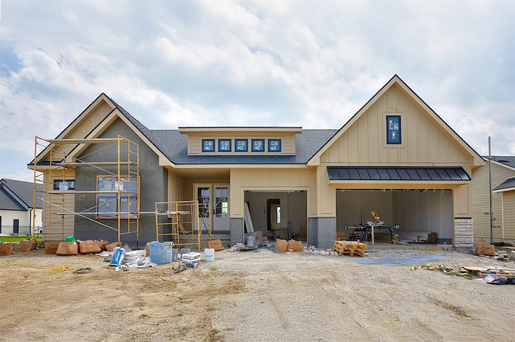18190 Hidden Knl, Clive, IA 50325 - view of front of house featuring board and batten siding, a shingled roof, and a garage