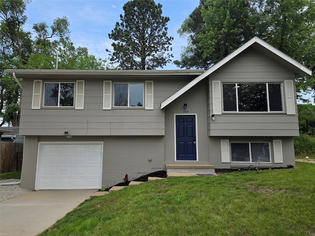 108 E Philip St, Des Moines, IA 50315 - bi-level home featuring an attached garage and concrete driveway