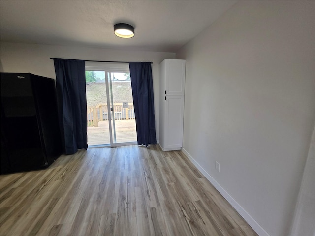 108 E Philip St, Des Moines, IA 50315 - unfurnished dining area featuring light wood finished floors and baseboards