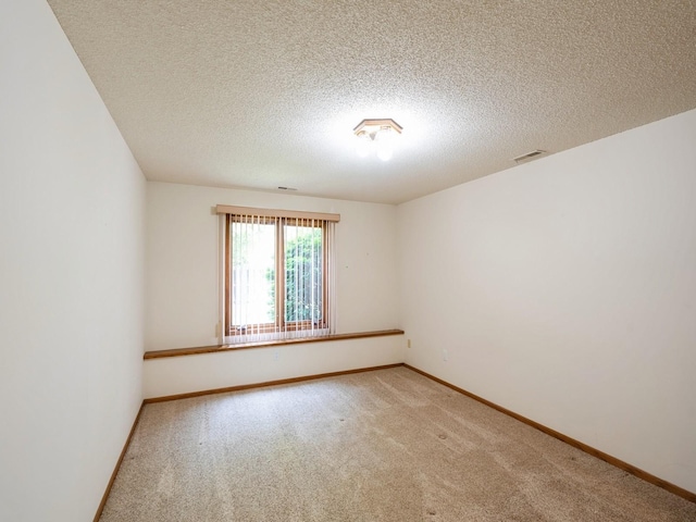 10823 Elmcrest Dr, Clive, IA 50325 - spare room featuring light colored carpet, baseboards, and a textured ceiling