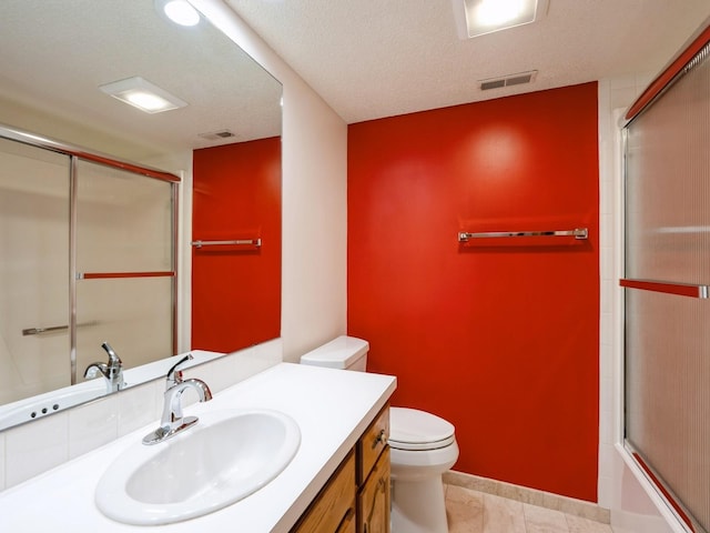 10823 Elmcrest Dr, Clive, IA 50325 - bathroom featuring toilet, vanity, enclosed tub / shower combo, and tile patterned floors