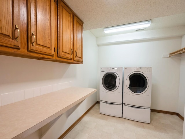 10823 Elmcrest Dr, Clive, IA 50325 - washroom featuring separate washer and dryer, cabinet space, baseboards, and light floors