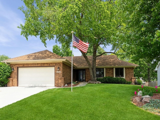 10823 Elmcrest Dr, Clive, IA 50325 - ranch-style home with a garage, a front yard, driveway, and brick siding