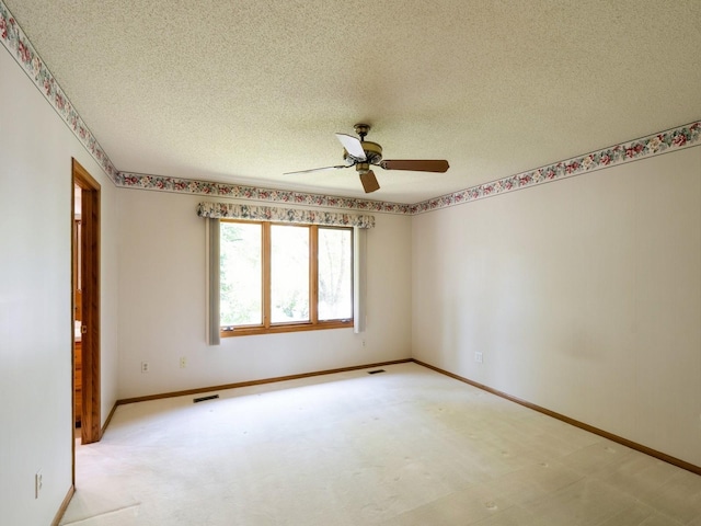 10823 Elmcrest Dr, Clive, IA 50325 - empty room featuring a textured ceiling, a ceiling fan, and baseboards