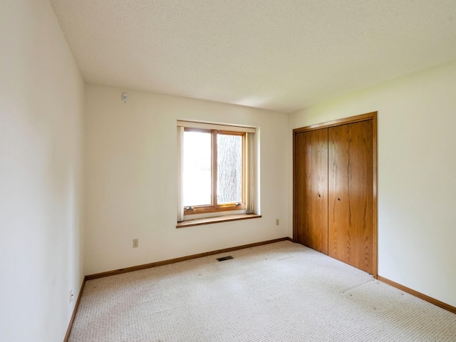 10823 Elmcrest Dr, Clive, IA 50325 - unfurnished bedroom with carpet, a closet, and baseboards
