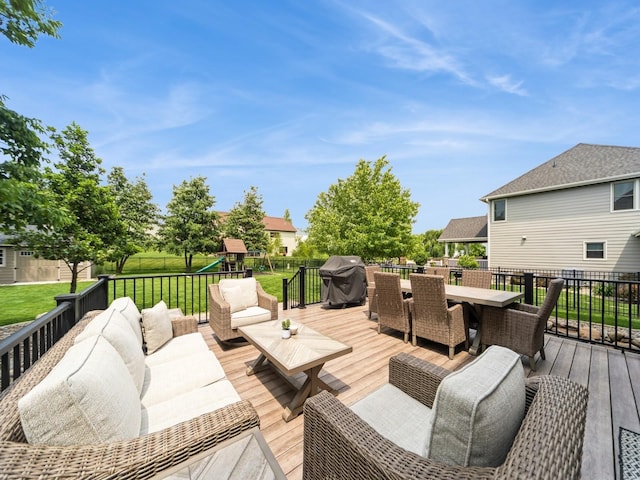 15903 Winston Ave, Urbandale, IA 50323 - wooden deck with outdoor dining space, a playground, an outdoor hangout area, and area for grilling