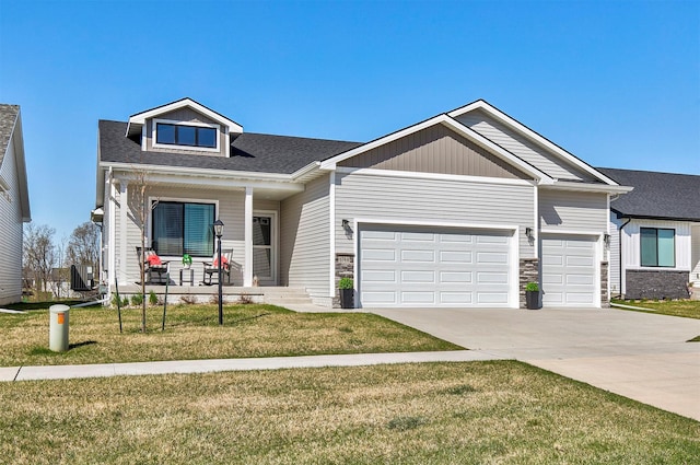 6744 NE 12th Ct, Des Moines, IA 50313 - view of front facade featuring a porch, driveway, a garage, a front yard, and roof with shingles