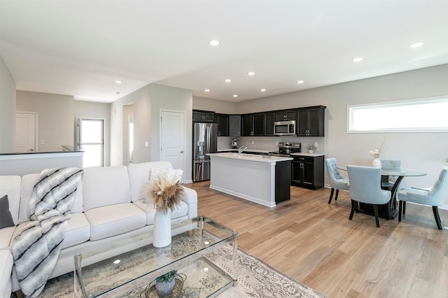6744 NE 12th Ct, Des Moines, IA 50313 - living area featuring healthy amount of natural light, light wood-type flooring, and recessed lighting