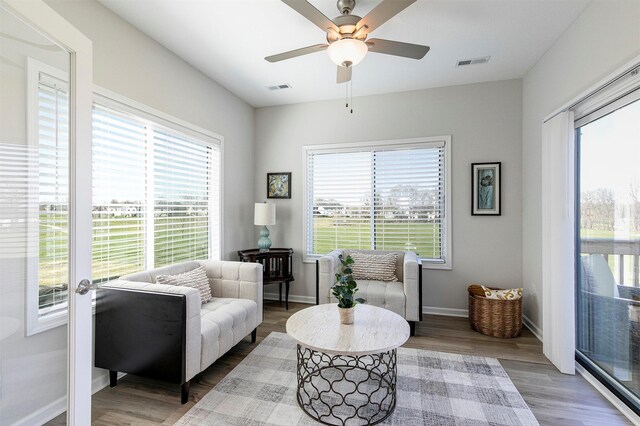 6744 NE 12th Ct, Des Moines, IA 50313 - living area with wood finished floors, a ceiling fan, and baseboards