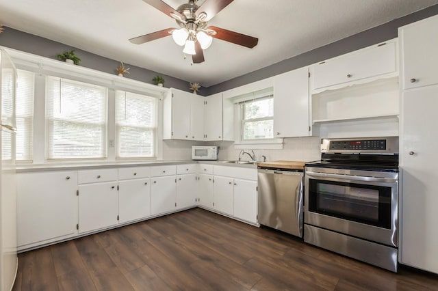 600 SE 2nd St, Grimes, IA 50111 - kitchen with appliances with stainless steel finishes, open shelves, a sink, ceiling fan, and white cabinetry