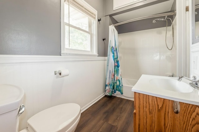 600 SE 2nd St, Grimes, IA 50111 - bathroom featuring toilet, wood finished floors, shower / tub combo, vanity, and a wainscoted wall