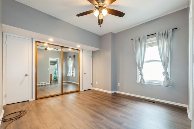 600 SE 2nd St, Grimes, IA 50111 - unfurnished bedroom featuring wood finished floors, baseboards, a closet, a ceiling fan, and recessed lighting