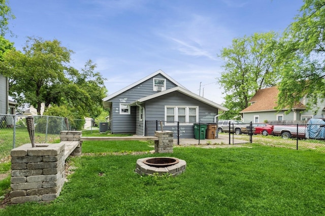 600 SE 2nd St, Grimes, IA 50111 - back of property featuring a gate, a fire pit, and central AC
