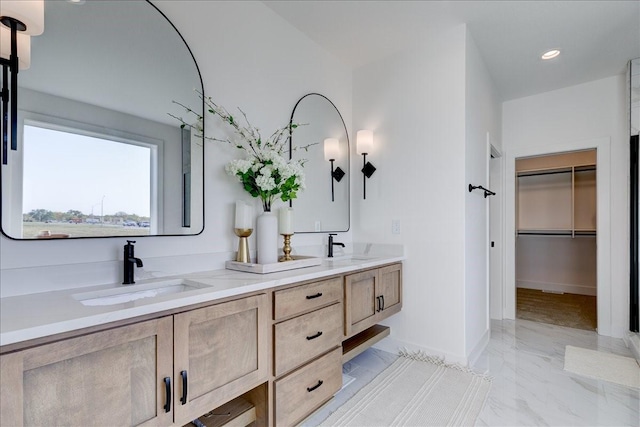 3736 NW 183rd St, Clive, IA 50325 - bathroom with double vanity, marble finish floors, baseboards, and a walk in closet