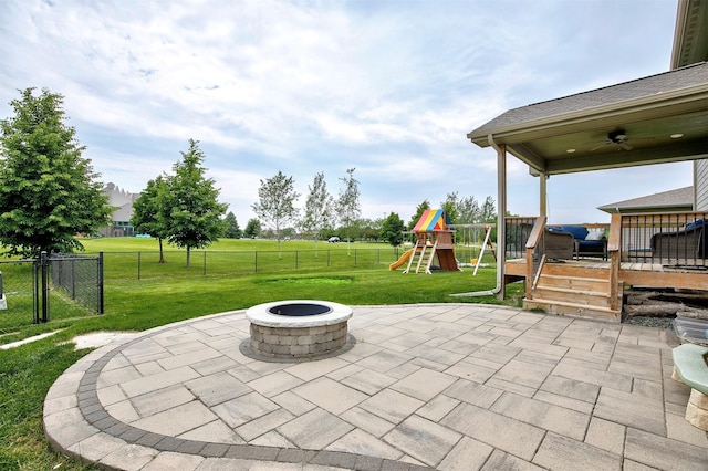 460 NE Bowman Dr, Waukee, IA 50263 - view of patio / terrace with a fire pit, a wooden deck, a playground, and a ceiling fan