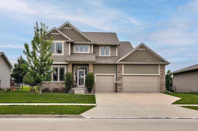 460 NE Bowman Dr, Waukee, IA 50263 - craftsman-style home featuring concrete driveway, stone siding, a front yard, and roof with shingles