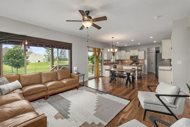 460 NE Bowman Dr, Waukee, IA 50263 - living area with a chandelier, a ceiling fan, dark wood-type flooring, and recessed lighting