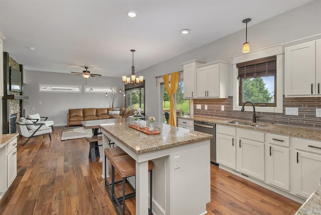460 NE Bowman Dr, Waukee, IA 50263 - kitchen featuring stainless steel dishwasher, a sink, decorative backsplash, white cabinets, and recessed lighting