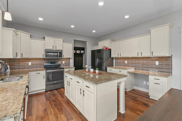 460 NE Bowman Dr, Waukee, IA 50263 - kitchen featuring stainless steel appliances, a sink, decorative backsplash, white cabinets, and recessed lighting