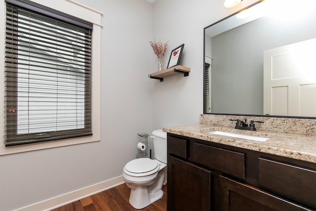 460 NE Bowman Dr, Waukee, IA 50263 - bathroom featuring wood finished floors, toilet, vanity, and baseboards