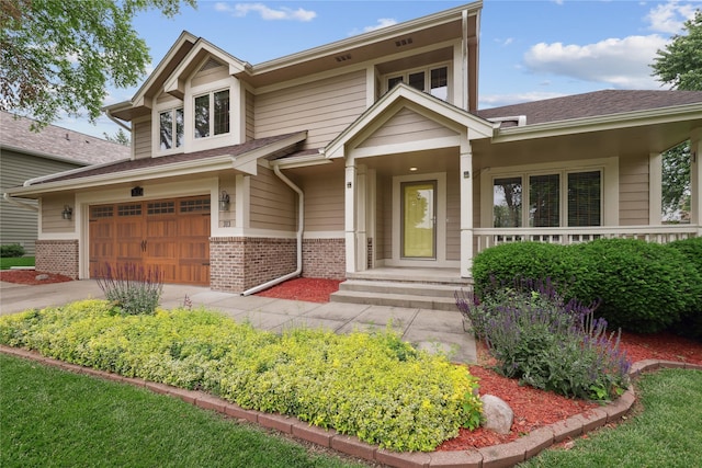 313 29th St, West Des Moines, IA 50265 - view of front facade featuring brick siding, an attached garage, and driveway