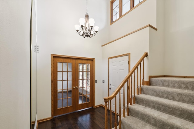 313 29th St, West Des Moines, IA 50265 - entryway featuring a chandelier, stairs, wood finished floors, a towering ceiling, and french doors