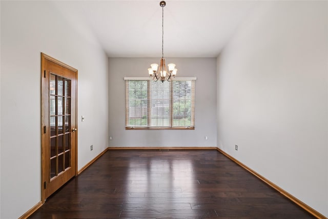 313 29th St, West Des Moines, IA 50265 - empty room featuring a chandelier, wood finished floors, and baseboards