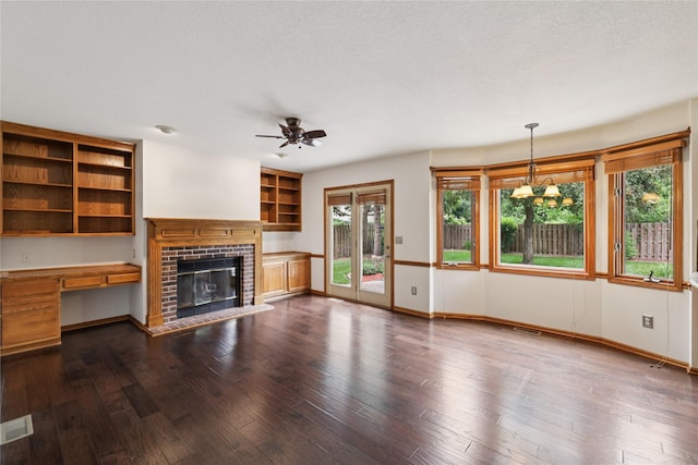 313 29th St, West Des Moines, IA 50265 - unfurnished living room featuring ceiling fan, a fireplace, baseboards, and dark wood-style flooring