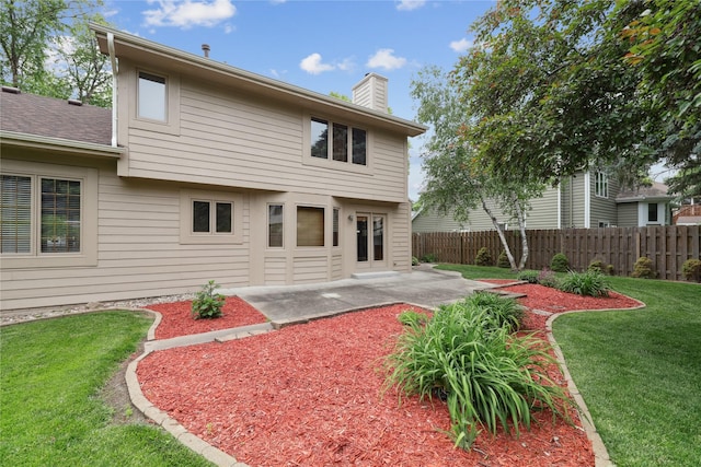 313 29th St, West Des Moines, IA 50265 - back of property with a chimney and a patio